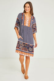 Model Elhana wearing size 10 of the Sun Dress in colour Navyprint (Blue), from the front, showing the whole outfit