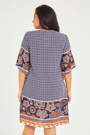 Model Terri-Leigh wearing size 14 of the Sun Dress in colour Navyprint (Blue), from the back