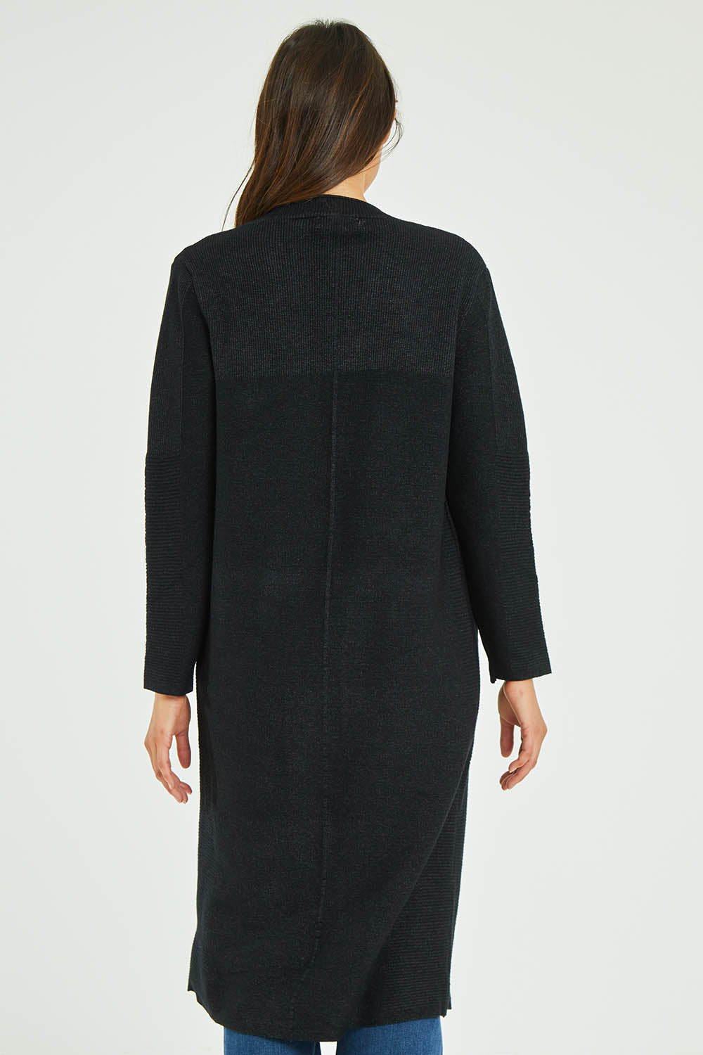 Model Madeline wearing size S-M of the Relaxed Rib Cardigan in colour Black (Black), from the back