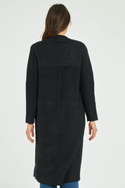 Model Madeline wearing size S-M of the Relaxed Rib Cardigan in colour Black (Black), from the back
