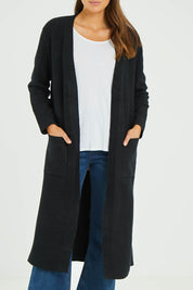 Model Madeline wearing size S-M of the Relaxed Rib Cardigan in colour Black (Black), from the front, cropped image