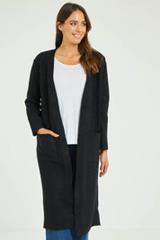 Model Madeline wearing size S-M of the Relaxed Rib Cardigan in colour Black (Black), from the front, cropped image