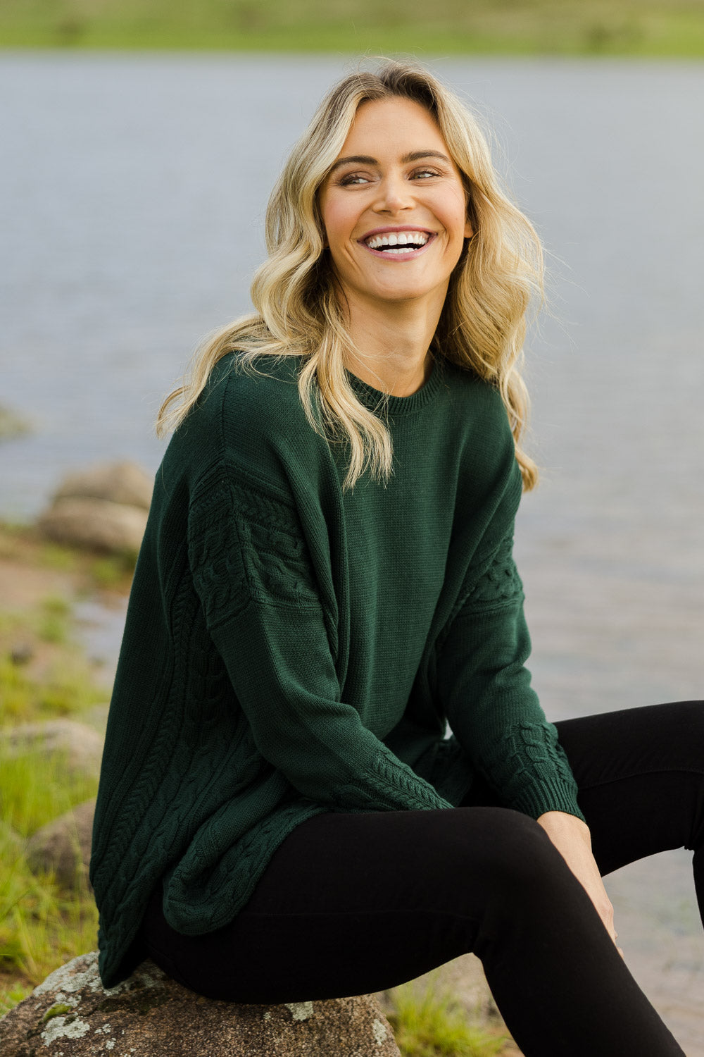Model Alice wearing size OneSize of the Poppy Knit in colour Forest (Green), from the front, showing the whole outfit