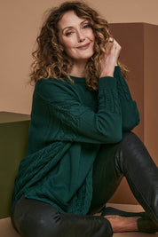 Model Emma wearing size OneSize of the Poppy Knit in colour Forest (Green), from the front, showing the whole outfit