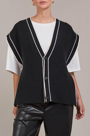 A model wearing the Avino Knit Vest in colour Black (Black), from the front, cropped image