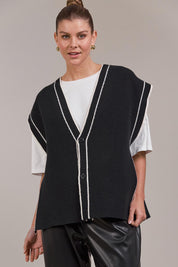A model wearing the Avino Knit Vest in colour Black (Black), from the front, cropped image
