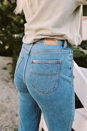 A model wearing the Hi Mom Curve in colour Blissblue (Blue), from the front, showing the whole outfit