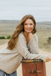 Model Sally wearing size S of the Verity V Neck Knit in colour Oatmeal, from the front, showing the whole outfit