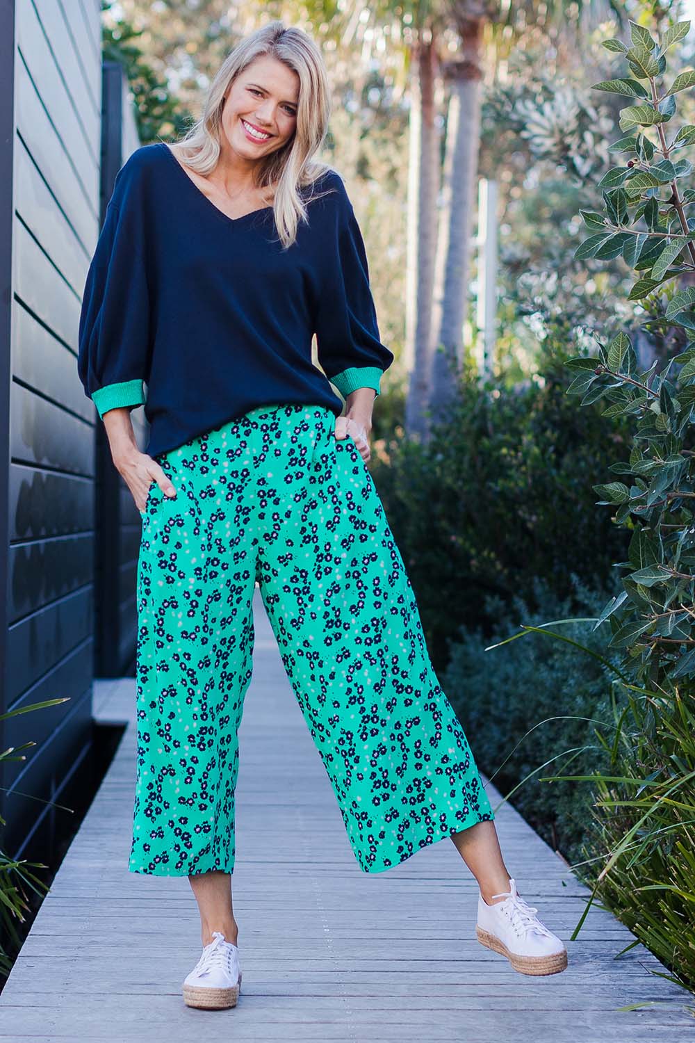 Model Kelly wearing size 10 of the Eloise Floral Pant in colour Greenflora (Green), from the front, showing the whole outfit