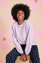 Model Aiyana wearing size 10 of the Piper Sweat in colour Lilac (Purple), from the front, showing the whole outfit