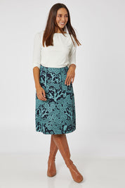 Model Cara wearing size S of the Avril Skirt Long Mikko in colour Greenink (Blue), from the front, showing the whole outfit