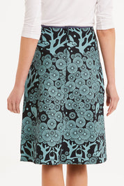 Model Madeline wearing size S of the Avril Skirt Long Mikko in colour Greenink (Blue), from the back