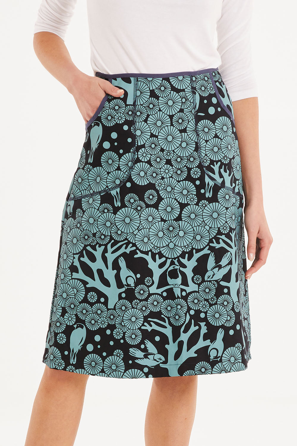 Model Madeline wearing size S of the Avril Skirt Long Mikko in colour Greenink (Blue), from the front, cropped image
