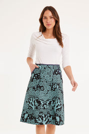 Model Madeline wearing size S of the Avril Skirt Long Mikko in colour Greenink (Blue), from the front, cropped image