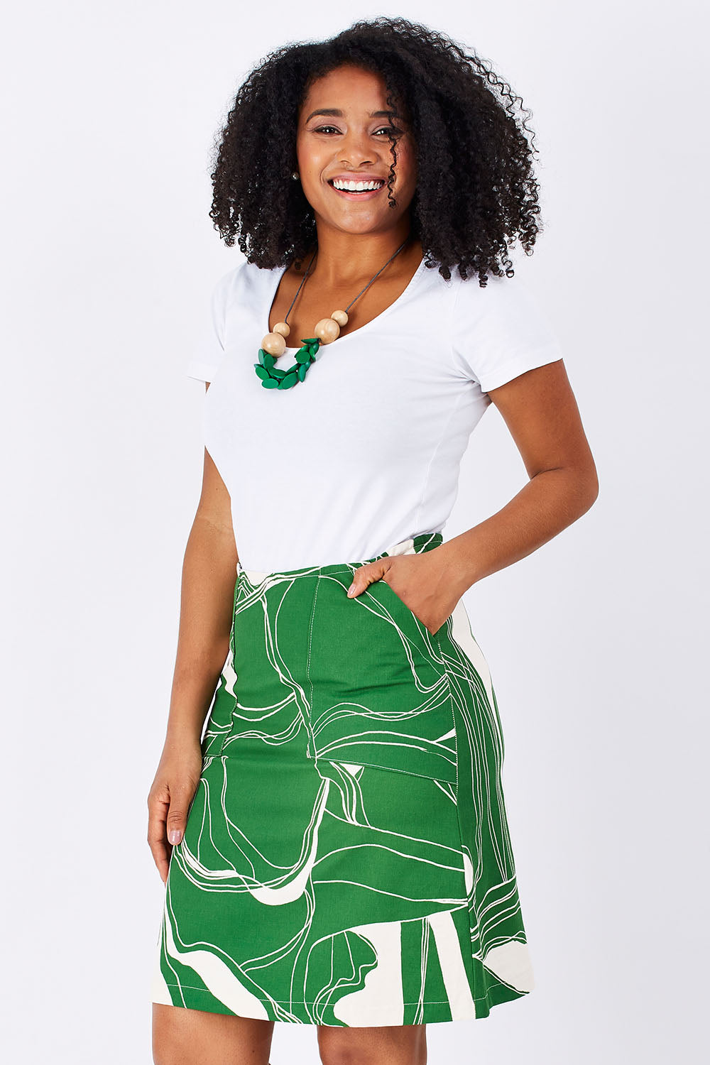 Model Grazi wearing size S of the Pocket Skirt in colour GreenNatur (Green), from the front, cropped image