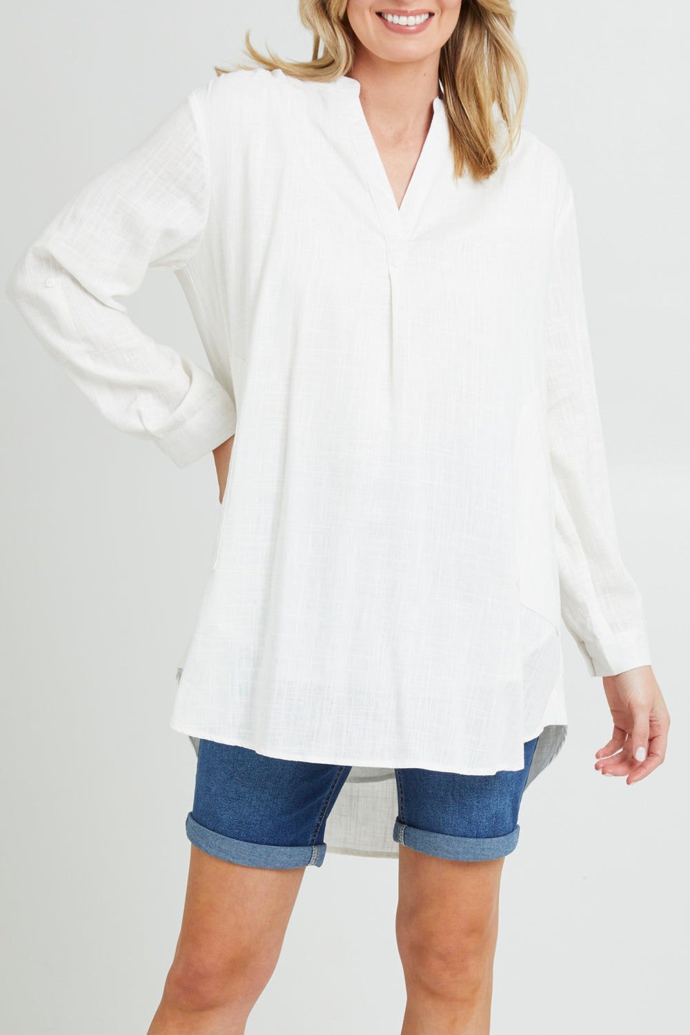 Model Grace wearing size 10 of the Beach Tunic Shirt in colour White (White), from the front, cropped image