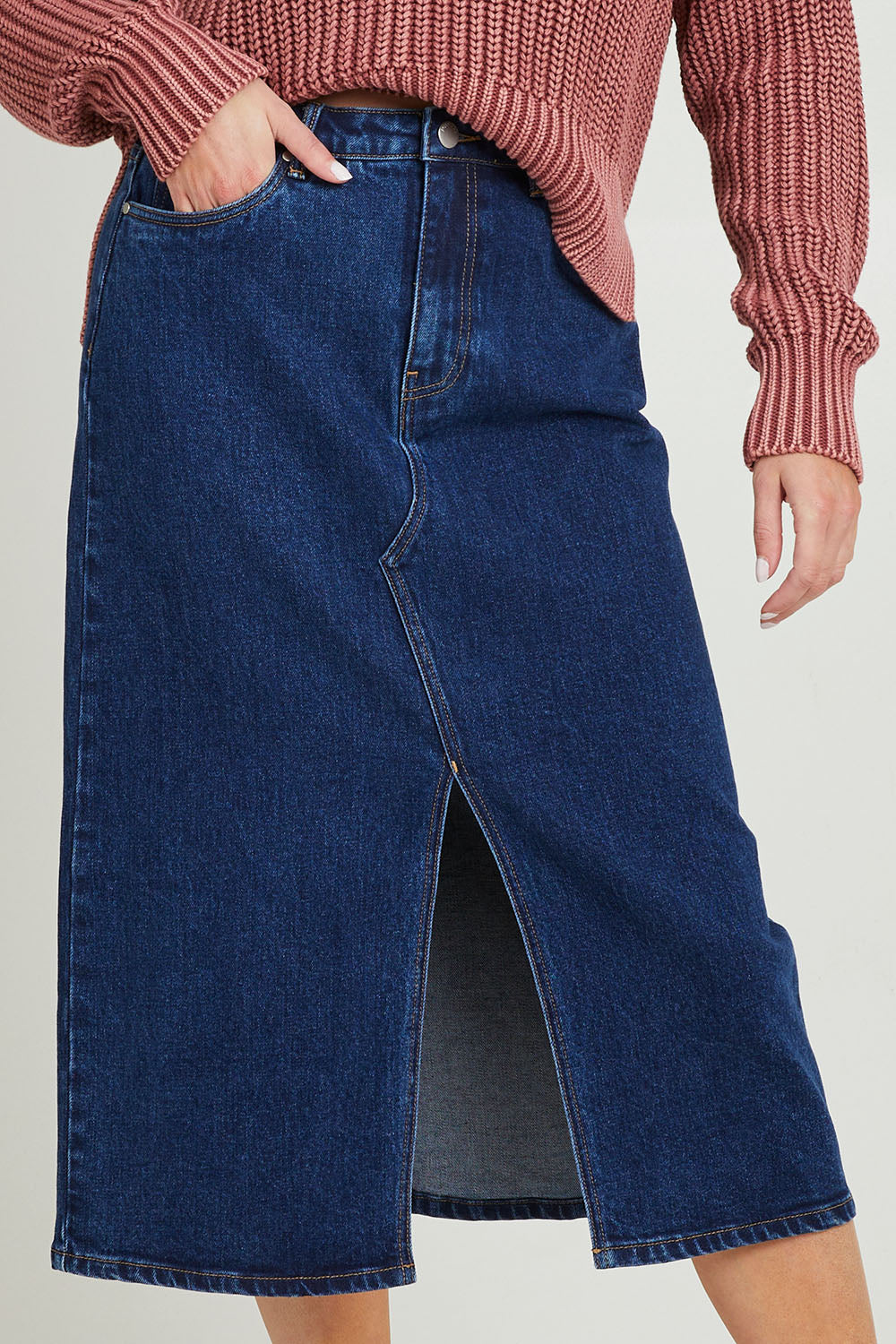 Model Grace wearing size 10 of the Scout Midi Skirt in colour Indidenim (Blue), from the front, cropped image