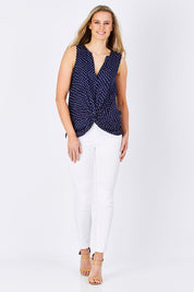 Model Maddy wearing size 10 of the Martinike Sleeveless Top in colour NavyPolka (Blue), from the front, showing the whole outfit