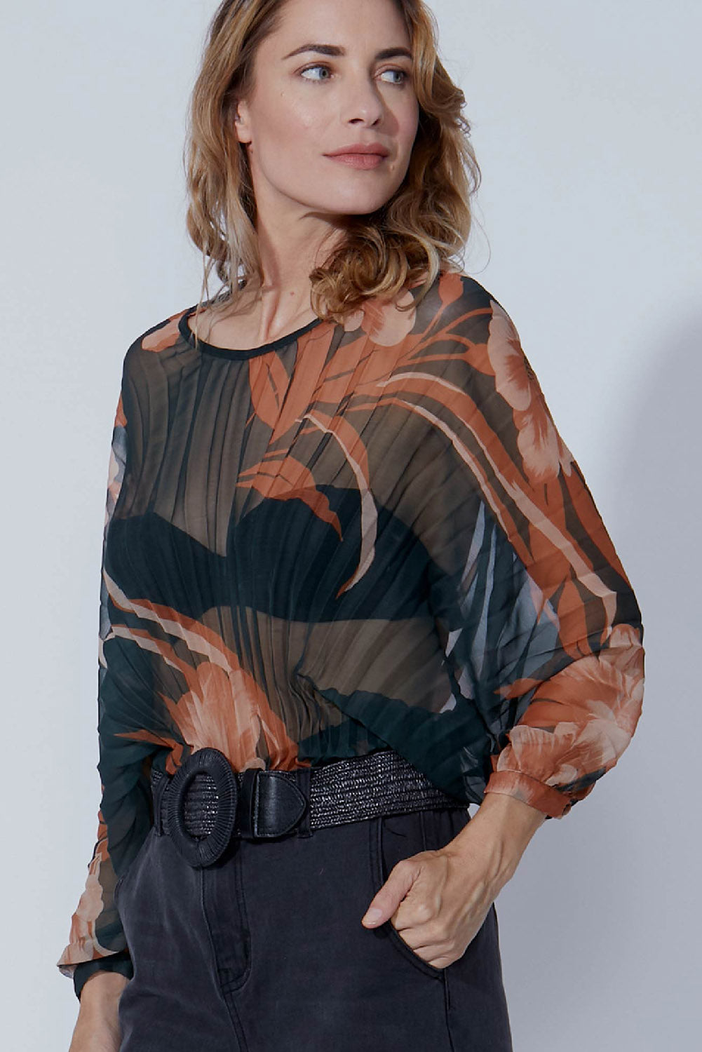 A model wearing size 10 of The Red Vineyard Top in colour Floral (Black), from the front, cropped image
