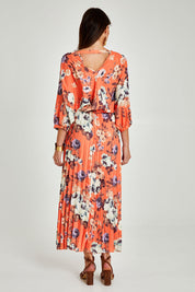 Model Madeline wearing size 10 of the Jolene Pleated Maxi Dress in colour Tangerine, from the back