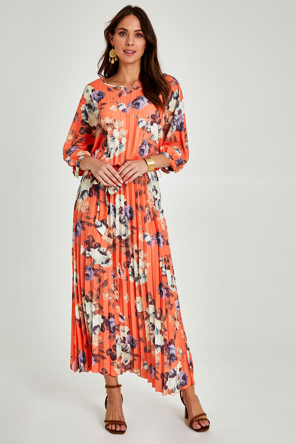Model Madeline wearing size 10 of the Jolene Pleated Maxi Dress in colour Tangerine, from the front, showing the whole outfit