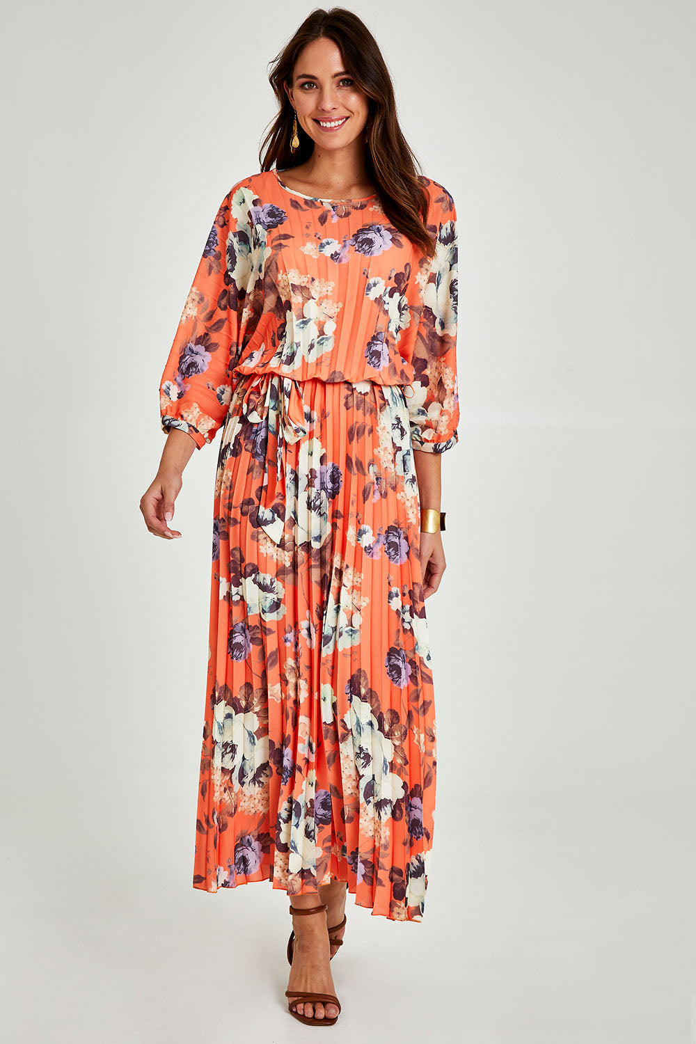 Model Madeline wearing size 10 of the Jolene Pleated Maxi Dress in colour Tangerine, from the front, showing the whole outfit