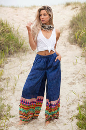 A model wearing the Durban Palazzo Pant in colour Durban (Blue), from the front, showing the whole outfit