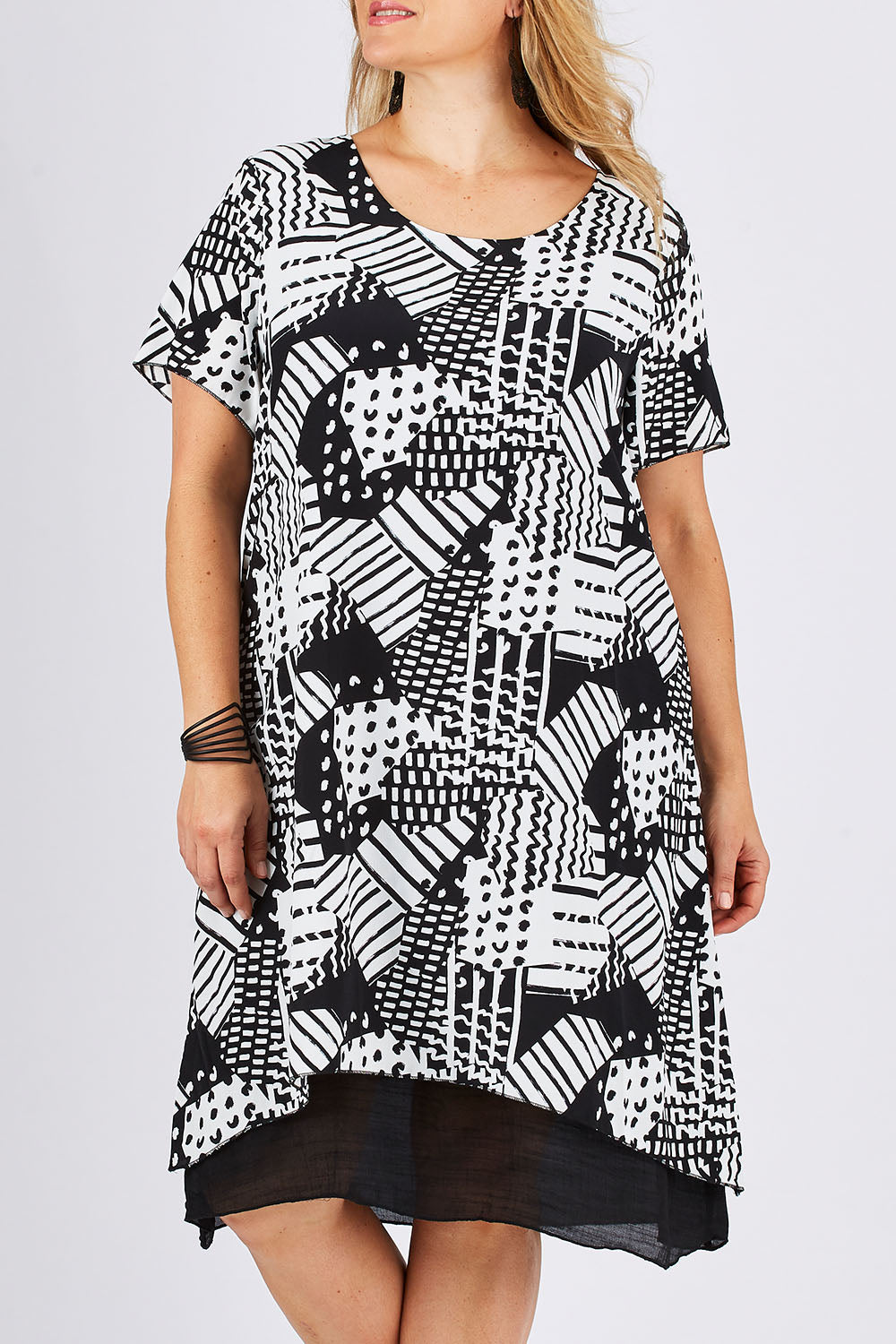 Model Ljubenka wearing size 18 of the Patterned Dress in colour BlackWhite (Black), from the front, cropped image