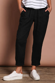 Model Madeline wearing size 10 of the Pull On Linen Pant in colour Black (Black), from the front, cropped image
