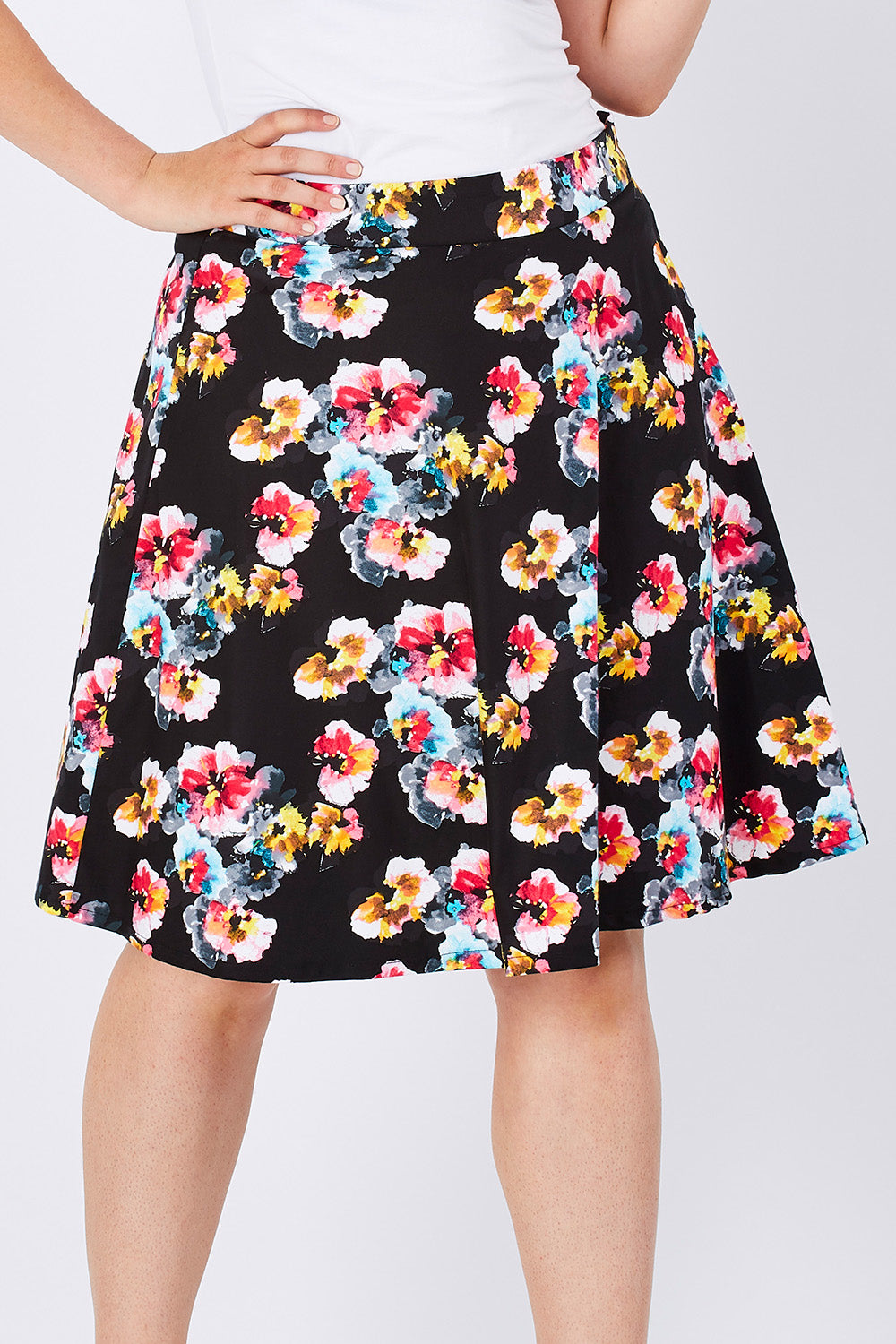 Model Jess wearing size 14 of the Printed Swing Skirt in colour Comical (Black), from the front, cropped image
