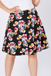 Model Jess wearing size 14 of the Printed Swing Skirt in colour Comical (Black), from the front, cropped image