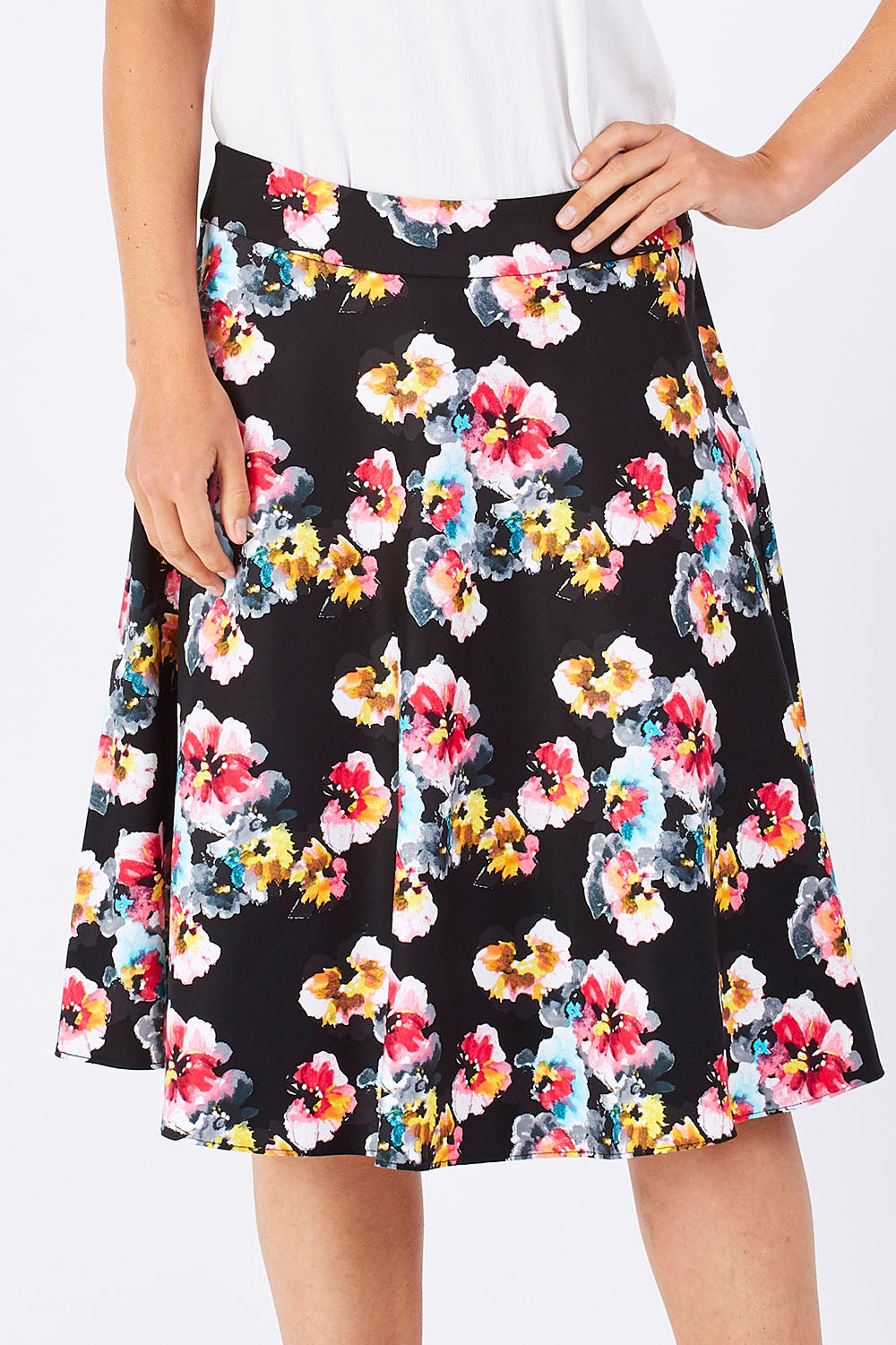 Model Jude wearing size 10 of the Printed Swing Skirt in colour Comical (Black), from the front, cropped image