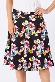 Model Jude wearing size 10 of the Printed Swing Skirt in colour Comical (Black), from the front, cropped image