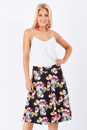 Model Jude wearing size 10 of the Printed Swing Skirt in colour Comical (Black), from the front, cropped image