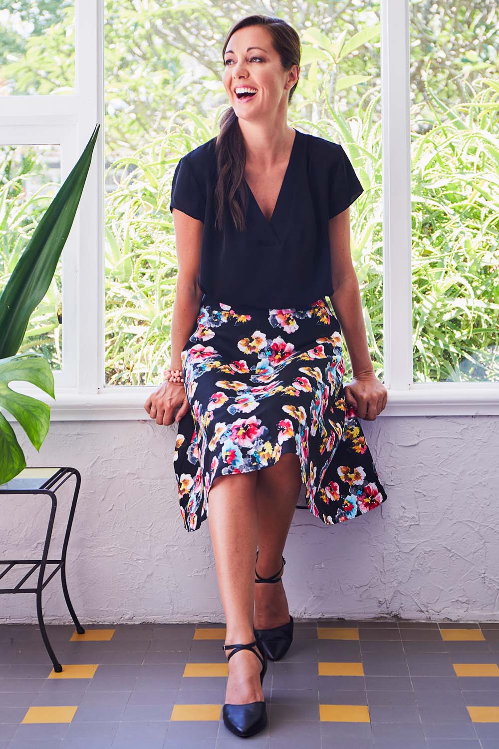 Model Lara wearing size 10 of the Printed Swing Skirt in colour Comical (Black), from the front, showing the whole outfit