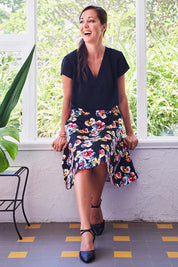 Model Lara wearing size 10 of the Printed Swing Skirt in colour Comical (Black), from the front, showing the whole outfit