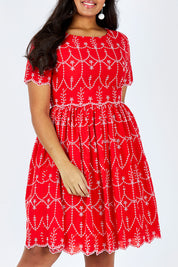 Model Shanaya wearing size 14 of the Printed Fit And Flare Dress in colour Embanglais (Red), from the front, cropped image