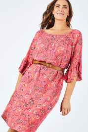 Model Abby wearing size 14 of the Off Shoulder Floral Dress in colour Persimmon (Pink), from the front, cropped image