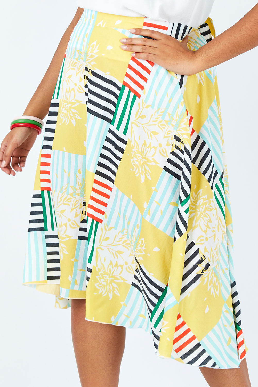 Model Shanaya wearing size 14 of the Tie Waist Skirt in colour Patched (White), from the front, cropped image