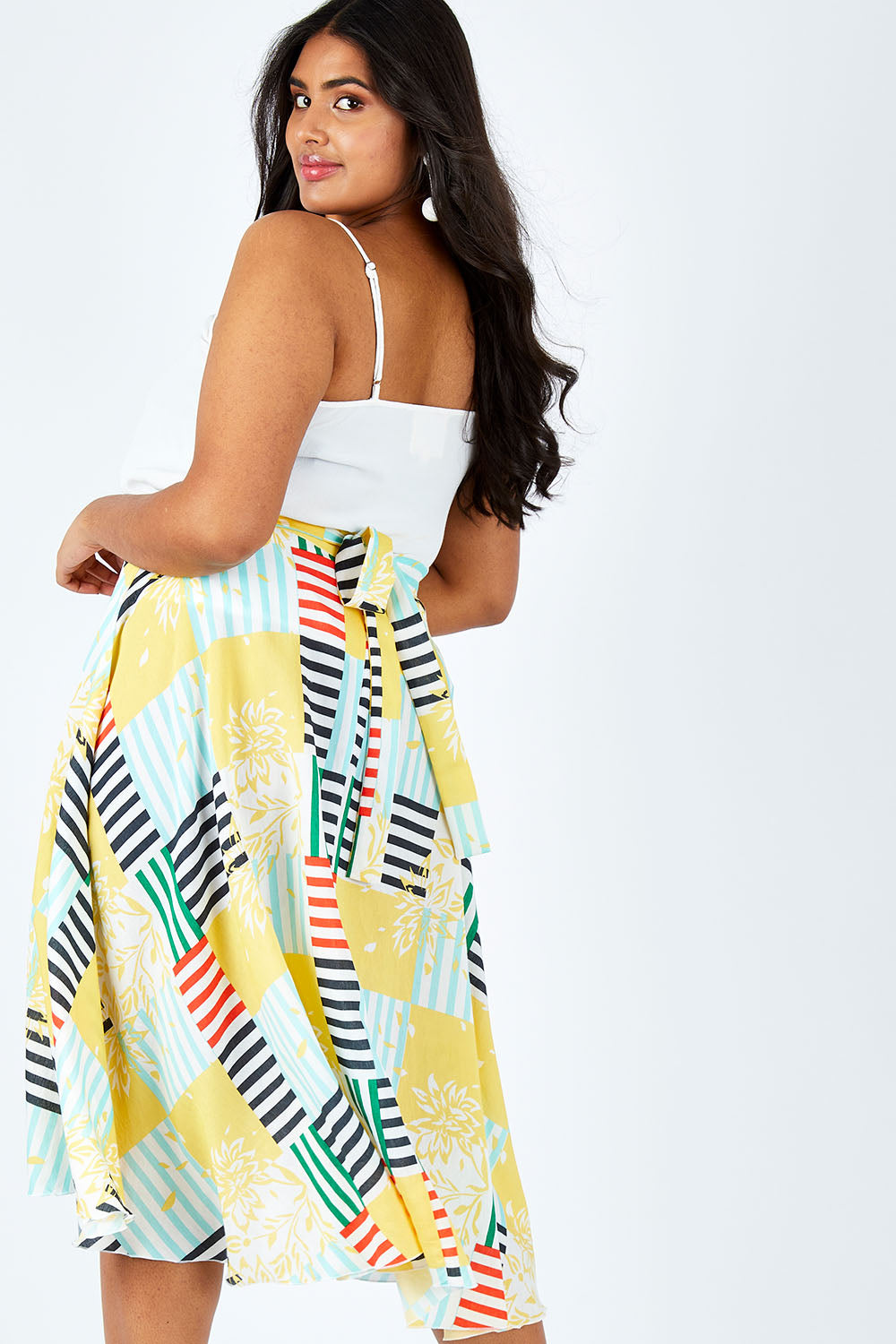 Model Shanaya wearing size 14 of the Tie Waist Skirt in colour Patched (White), from the front, cropped image
