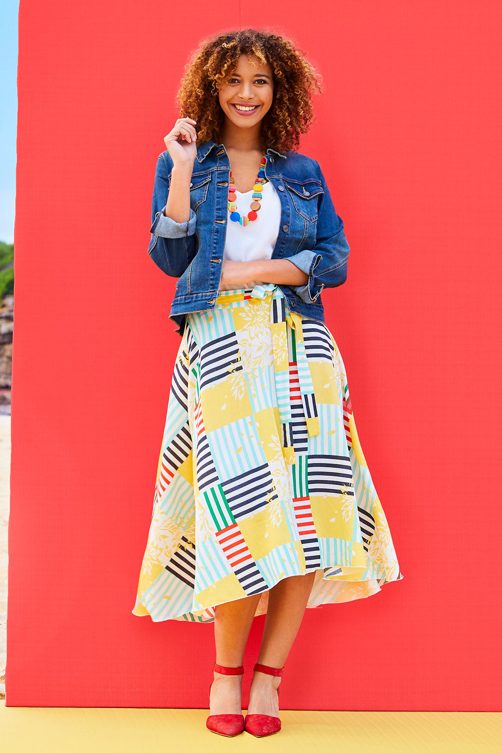Model Summer wearing size 10 of the Tie Waist Skirt in colour Patched (White), from the front, showing the whole outfit