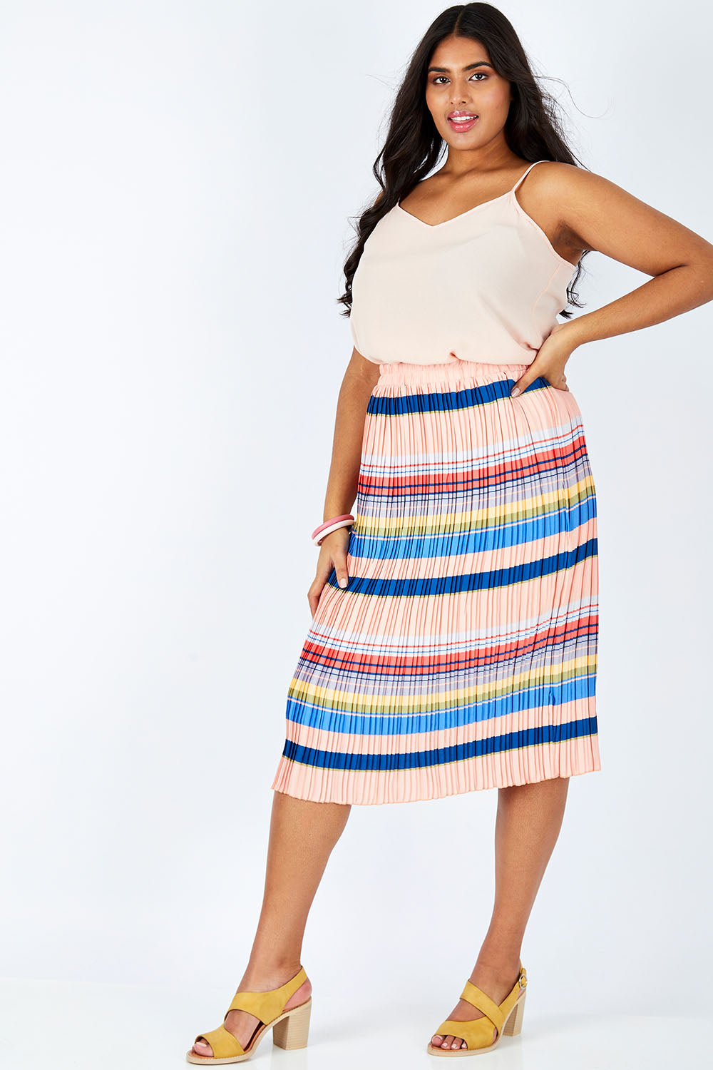 Model Shanaya wearing size 14 of the Pleated Stripe Skirt in colour Pleated (Pink), from the front, showing the whole outfit