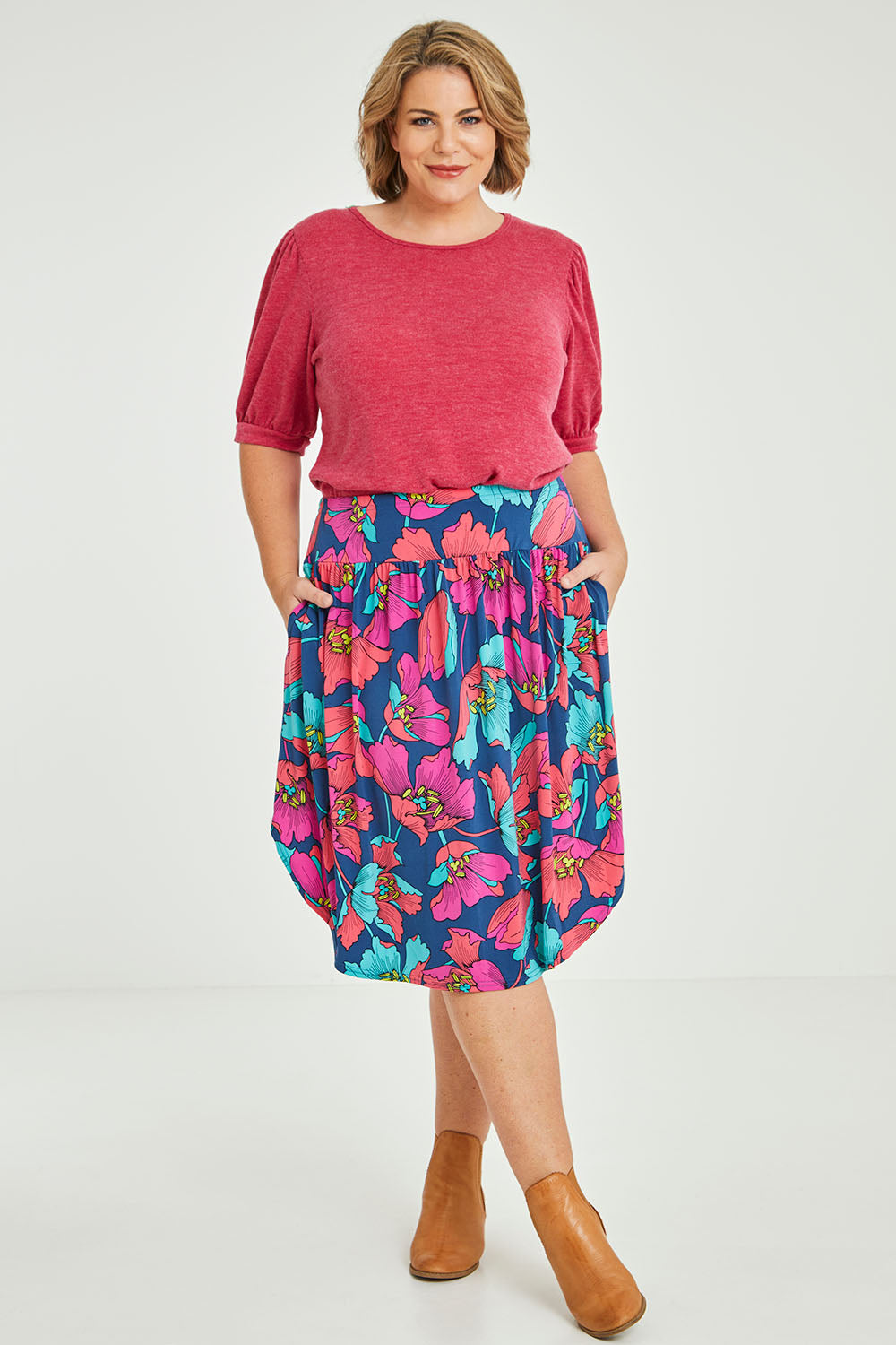 Model Fiona wearing size 16 of the Elastic Waist Curved Hem Skirt in colour Lilly (Blue), from the front, showing the whole outfit