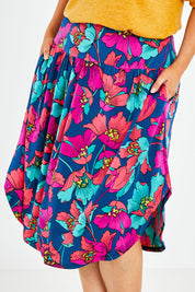 Model Jess wearing size 14 of the Elastic Waist Curved Hem Skirt in colour Lilly (Blue), from the front, cropped image