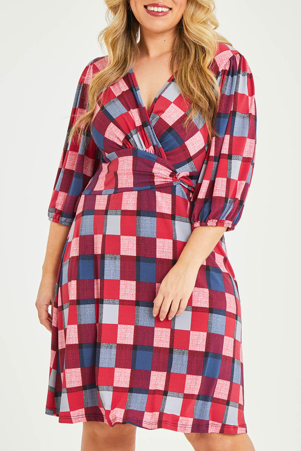 Model Katie wearing size 16 of the Gathered Waist Faux Wrap Dress in colour Checkered (Red), from the front, cropped image