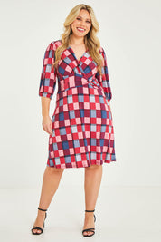 Model Katie wearing size 16 of the Gathered Waist Faux Wrap Dress in colour Checkered (Red), from the front, showing the whole outfit