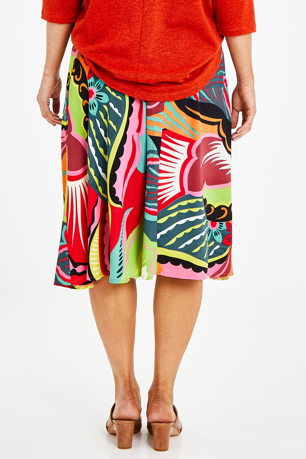 Model Laura wearing size 14 of the Printed Knee Length Skirt in colour Bloom (Pink), from the back