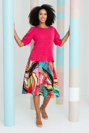 Model Schanez wearing size 10 of the Printed Knee Length Skirt in colour Bloom (Pink), from the front, showing the whole outfit