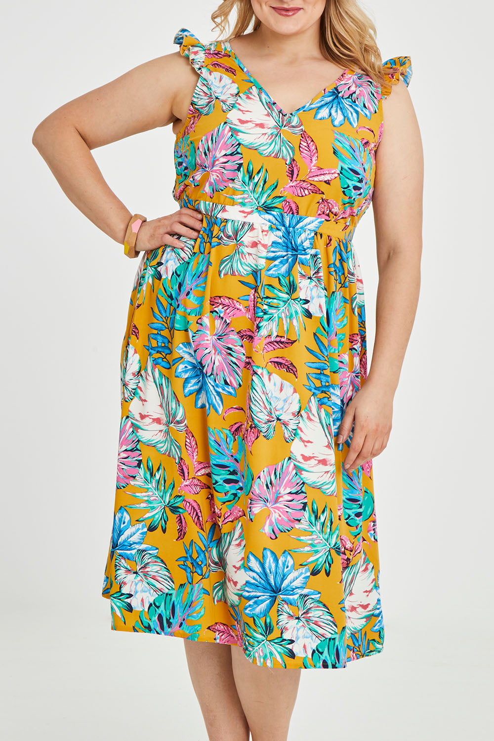 Model Keeara wearing size 16 of the V Neck Gathered Sleeve Dress in colour Garden, from the front, cropped image