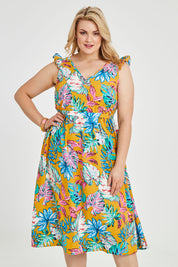 Model Keeara wearing size 16 of the V Neck Gathered Sleeve Dress in colour Garden, from the front, cropped image